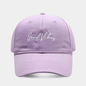 Detailed view of light purple baseball cap featuring Good Vibes embroidery and curved brim
