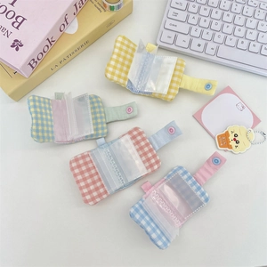 Mini checkered fabric photo albums in four pastel colors with button closure