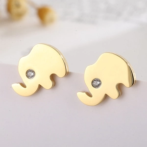 Macro detail of gold elephant stud earrings featuring a sparkling white zircon eye stone