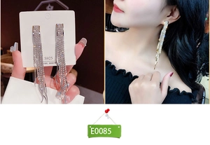 Close-up of elegant long silver tassel earrings with shimmering crystals and S925 studs