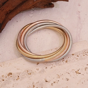 Three-tone layered spring snake chain bracelet in gold, silver, and rose gold finishes