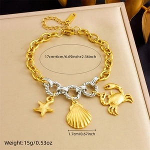 Detailed view of gold plated chain bracelet with starfish shell and crab charms