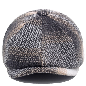 Close-up of retro herringbone tweed fabric texture on a winter newsboy flat cap