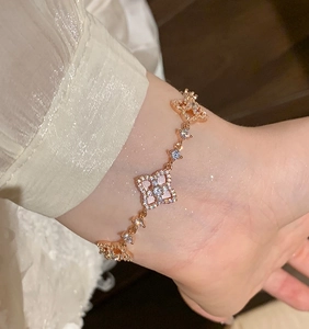 Detail of rose gold clover bracelet with pink shell inlay and sparkling zircon stones