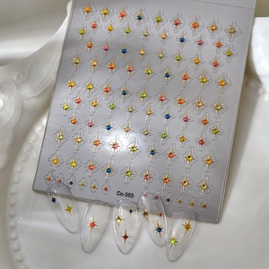Macro shot of 3D colorful star nail stickers with rhinestones on a decorative plate
