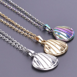 Macro shot of shell pendants in silver, gold, and iridescent finishes on O-chains