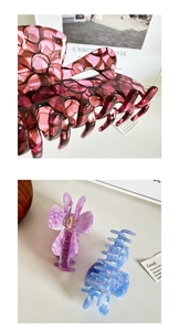 Detail of hollow heart acetate hair claws in burgundy, purple, and blue marble texture