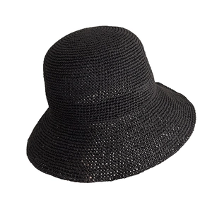Handcrafted black crochet sun hat with a minimalist round top design in woven paper straw