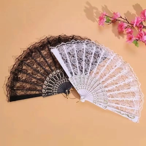 Elegant black and white hollow lace folding fans with decorative carved ribs and floral accents