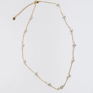Detail of S925 sterling silver stamp on the gold necklace extension chain with pearls