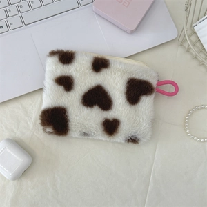 Flat lay of heart pattern plush makeup pouch with pink drawstring on aesthetic desk