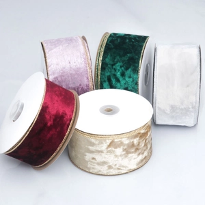 Close-up of velvet ribbons in red, green, and champagne with metallic wired edges