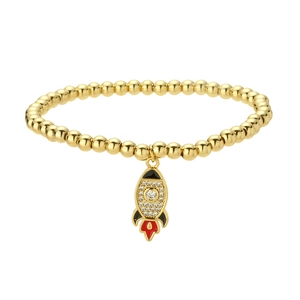 Gold beaded bracelet with rocket pendant featuring red enamel and sparkling stones