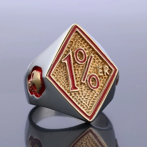 Detailed view of motorcycle style 1% ER ring with red oil drip and gold skull accents