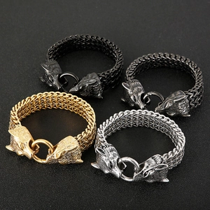 Detail of wolf head braided chain bracelets in gold, silver, black and gunmetal grey