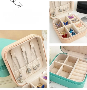 Macro view of portable jewelry box with necklace hooks and ring slots in pink and green