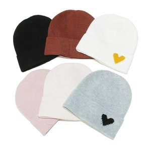 Solid color knitted beanies with embroidered hearts in multiple colors for winter