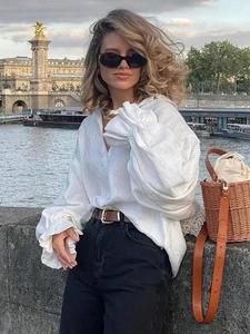 Women's white linen long sleeve shirt with flare sleeves and V-neck in a relaxed fit
