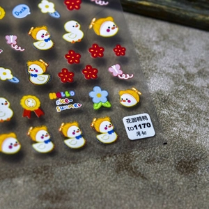 Close-up of 5D embossed nail stickers featuring cute garden ducks and colorful flowers