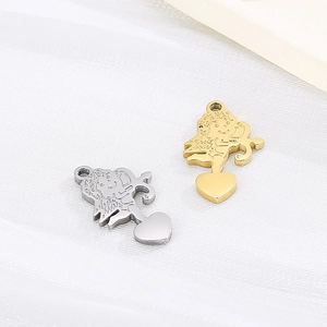 Polished stainless steel angel cupid pendants in silver and gold finishes on white fabric