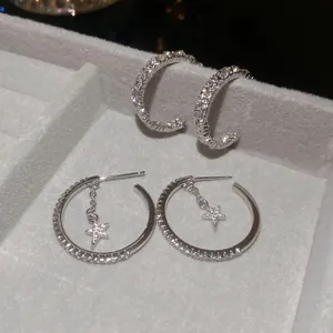 Silver C-shaped stud earrings and star drop hoops set with sparkling cubic zirconia