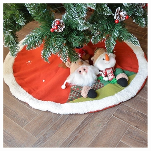 Detail of red Christmas tree skirt with plush 3D Santa and Snowman dolls on wood floor