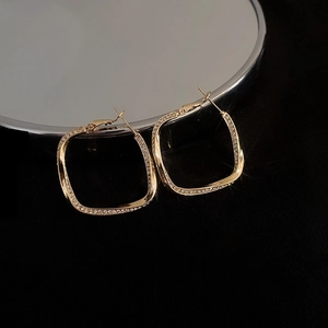 Elegant gold plated twisted square hoop earrings with sparkling crystals on mirror