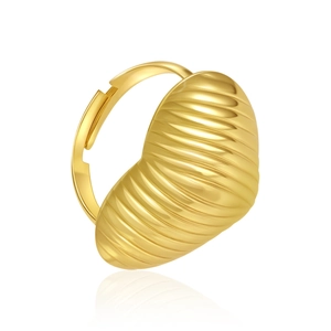 Detail of gold heart ring with textured ribbing on a reflective white surface