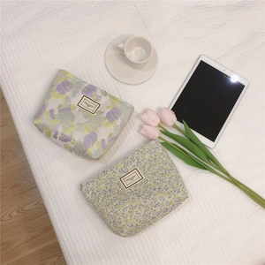 Detail of floral makeup pouches with Time To Party labels and zipper closures
