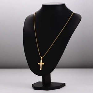 Polished gold stainless steel cross pendant necklace displayed on a black neck bust