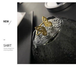 Close-up of golden butterfly ring featuring hollow design and refined metal texture