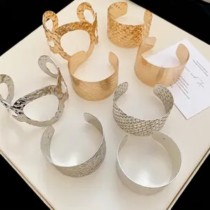 Irregular geometric metallic open cuff bracelets in gold and silver textured finishes
