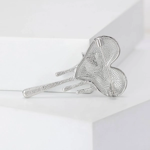 Macro detail of silver fluid heart brooch back showing texture and secure pin clasp