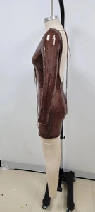 Side view of brown sequin mini dress featuring halter neck ties and backless design