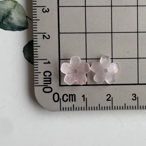 Detail showing two 1cm gradient flower beads on a scale for size reference