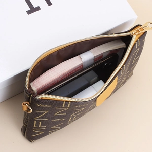Classic brown logo print small crossbody bag with gold zipper and spacious interior