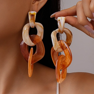 Macro shot of chunky acrylic chain earrings with mixed marble texture on model