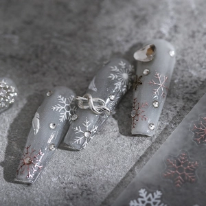Grey snowflake nail stickers with 3D silver knots and rhinestones for winter manicure