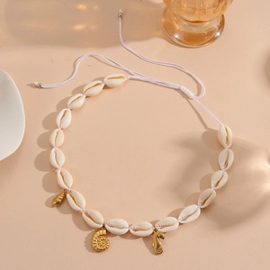Detail of adjustable white shell necklace with gold seahorse and seashell pendants