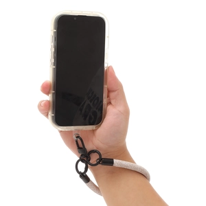 Beige braided phone wrist strap with black metal clasp held by hand on white background