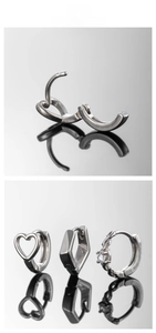 Detail showing silver stainless steel huggie earrings with heart and geometric designs