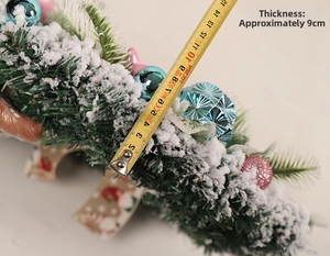 Detail showing approximately 9cm thickness of the flocked Christmas wreath using a ruler