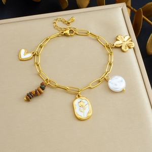 Close-up of gold stainless steel bracelet with heart charms and tiger eye stone beads