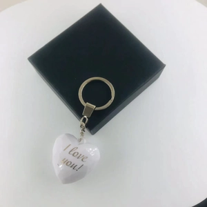 White acrylic heart keychain with I love you script on a black display box