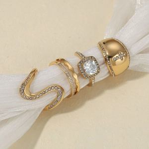 Gold stainless steel ring set featuring snake shape and cross patterns with cubic zirconia