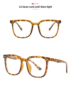 Detailed close-up of tortoise shell blue light blocking frames with metal arrow accents