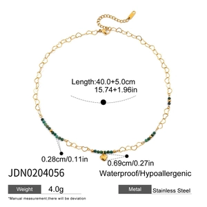 Detail of stainless steel necklace with green beads, heart pendant and size specs