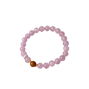 Minimalist beaded bracelet with pink translucent stones and gold accents on white backdrop