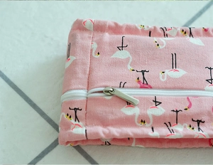 Detail of pink flamingo pattern cooling wrap with premium metal zipper and fabric texture