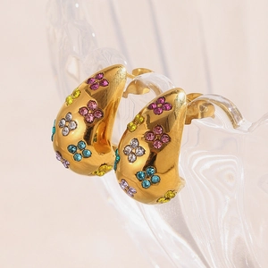 Macro detail of 18K gold plated clover earrings set with vibrant multicolor rhinestones